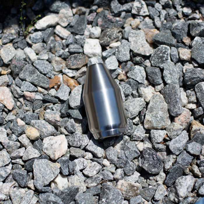 High‑pressure stainless steel jetting nozzle on gravel surface, precision‑machined orbital cleaning and cutting tool used for hydro‑excavation and industrial surface preparation with rotating zero‑degree water stream performance.