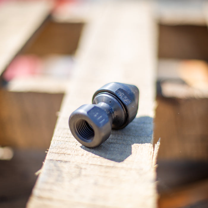 US Jetting high‑pressure sewer jetting adapter with threaded connection, shown on a wooden pallet, used for attaching Egghead Penetrator nozzles and other jetting tools; durable case‑hardened steel fitting compatible with 1/2", 3/4", and 1" hoses for 2,000–10,000 PSI drain and sewer cleaning applications.