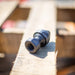 US Jetting high‑pressure sewer jetting adapter with threaded connection, shown on a wooden pallet, used for attaching Egghead Penetrator nozzles and other jetting tools; durable case‑hardened steel fitting compatible with 1/2", 3/4", and 1" hoses for 2,000–10,000 PSI drain and sewer cleaning applications.