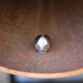 Stainless steel ball jet nozzle inside a metal pipe, high-pressure sewer jetting nozzle for drain and pipe cleaning, durable hydro jetting ball nozzle for removing grease, debris, and blockages in plumbing systems