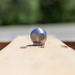 Stainless steel ball jet nozzle on a wooden pallet, high-pressure sewer jetting nozzle for drain and pipe cleaning, durable hydro jetting ball nozzle for removing grease, debris, and blockages in plumbing systems