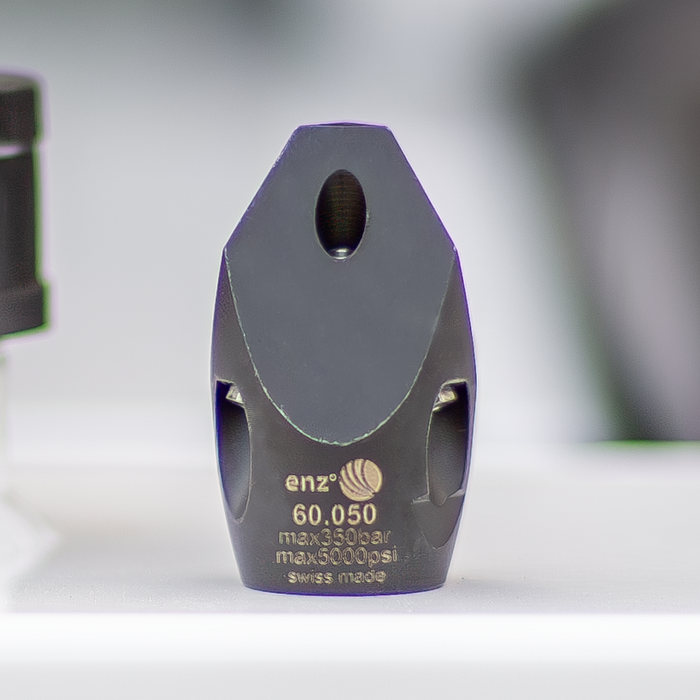 Enz high‑pressure sewer jetting nozzle shown in close‑up on a US Jetting machine, featuring Swiss‑made stainless steel construction with multiple precision jet ports. Professional chisel‑style sewer cleaning nozzle rated to 350 bar / 5000 psi for cutting through grease, light roots, and general pipe debris, engineered for forward penetration and rear‑jet propulsion in drain and sewer maintenance applications.