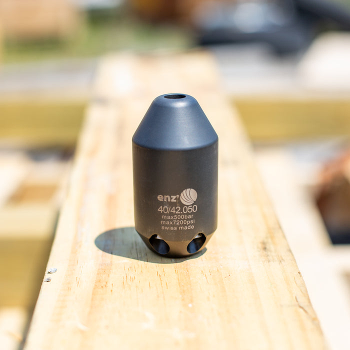 Enz Grenade 40/42.050 high‑pressure sewer jetting nozzle, Swiss‑made stainless steel rotary cleaning nozzle rated to 500 bar / 7200 psi, shown on a wooden surface for industrial drain and pipe cleaning applications.