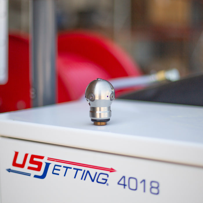 Super Spin nozzle placed on top of a US Jetting 4018 jetter, showcasing high-pressure sewer cleaning equipment, durable jetting nozzle design, and professional drain cleaning machinery for industrial and commercial use.
