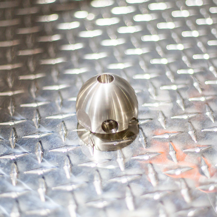Warthog stainless‑steel descaling head for WH Classic sewer jetting nozzles, precision‑machined spherical replacement head designed for 1/2" and 3/4" Warthog tools. Features 105‑degree rear jet pattern with optional plugged front port to maximize descaling and pulling power, removing scale, tuberculation, corrosion, soap, and mineral buildup in sewer and drain lines. Head‑only attachment used to convert standard Warthog nozzles into high‑performance descaling tools.