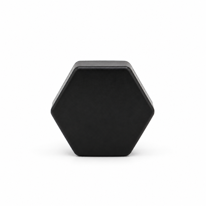 Straight-on view of the solid black hexagonal face of a threaded cap against a white background