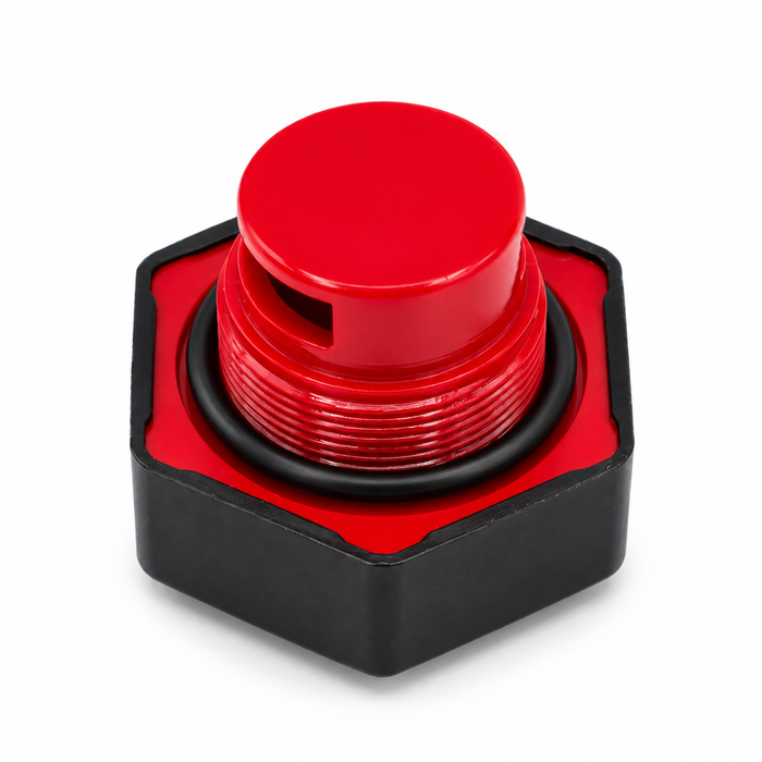 Angled underside view of a black hexagonal cap with a red threaded insert, side opening, and black sealing ring