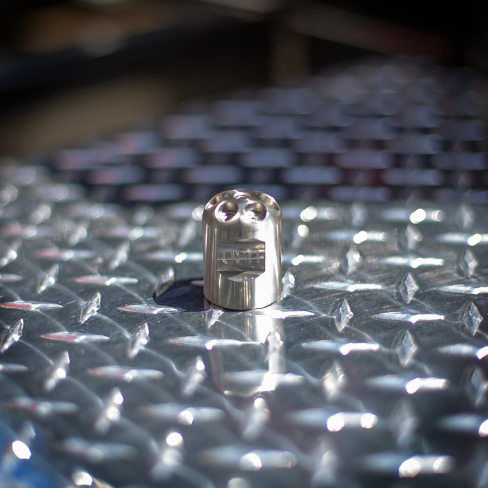 Digger sewer jetting nozzle on diamond plated surface – stainless steel front-jet drain cleaning nozzle engineered to push debris, sludge, and pipe scale out of small pipes; no rear jets for maximum forward water pressure, ideal for pipe lining prep and short runs under 100 feet requiring manual feed.